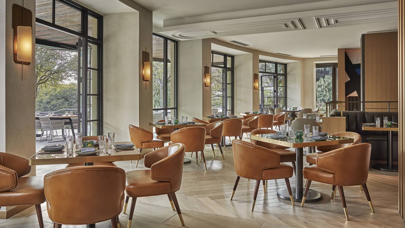 The airy dining room at Ciclo, featuring floor-to-ceiling windows.
