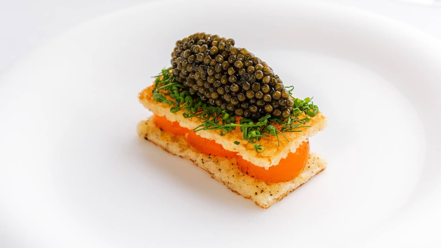 Plate of egg toast and caviar with herbs
