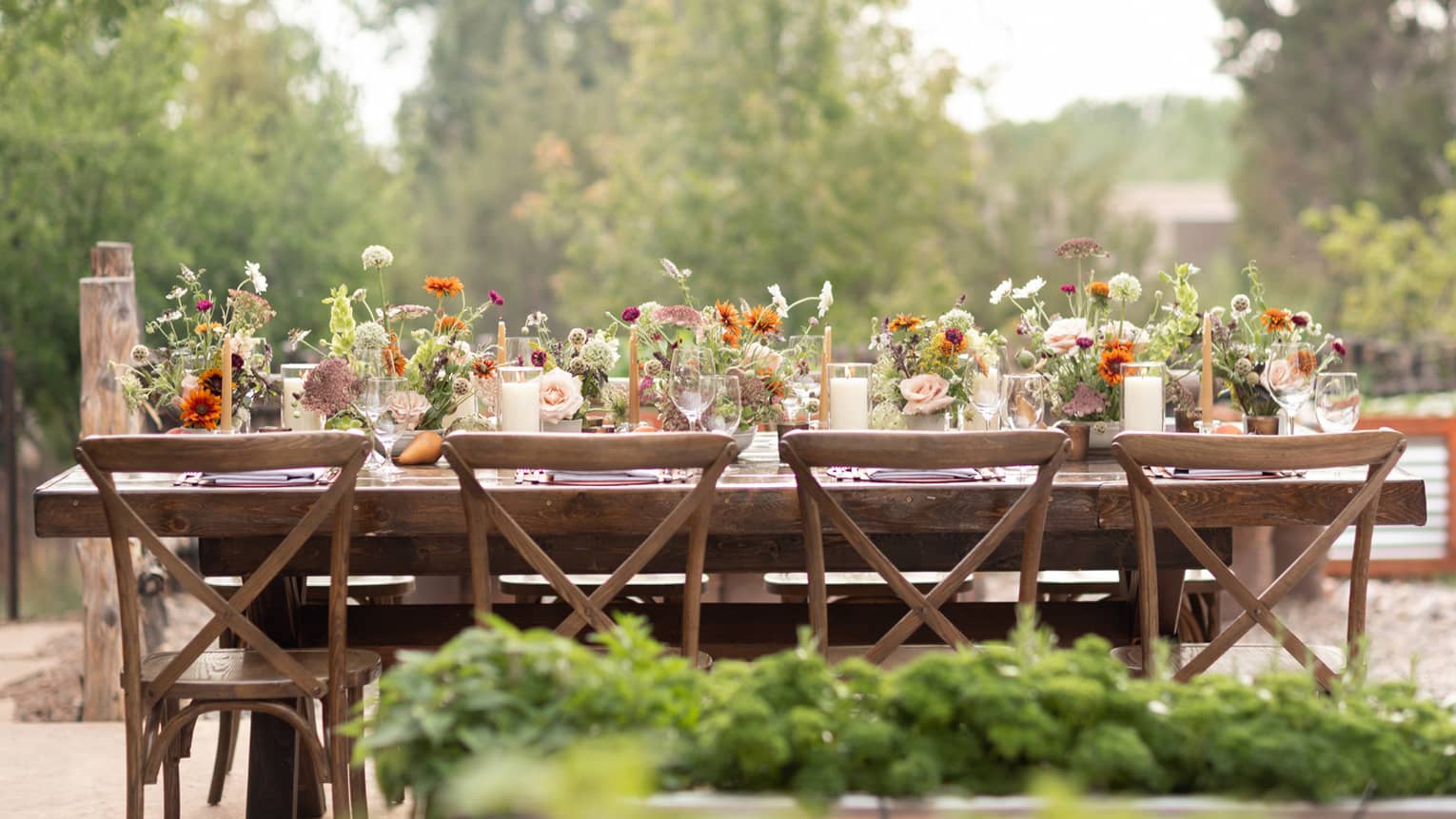 A table outside covered in flowers.