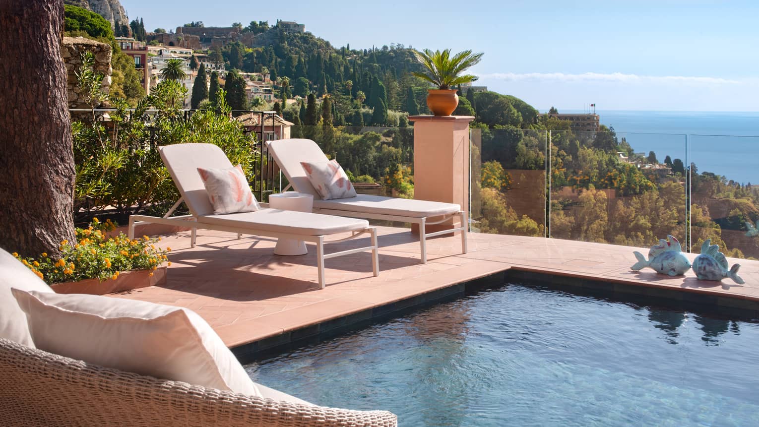 Private, sea-view terrace with two lounge chairs and plunge pool
