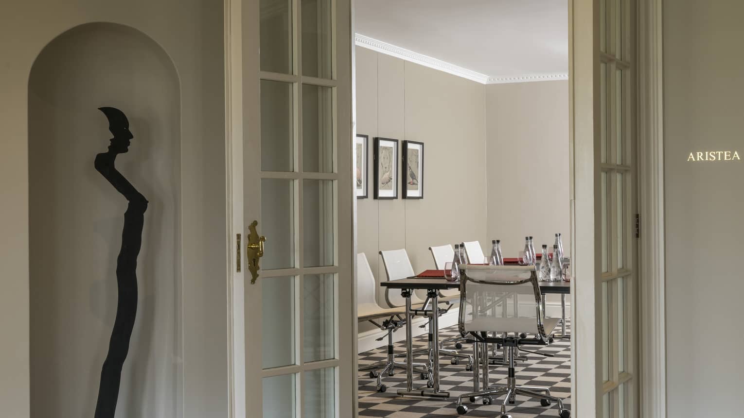 View through white French doors to table in Aristia Meeting Room