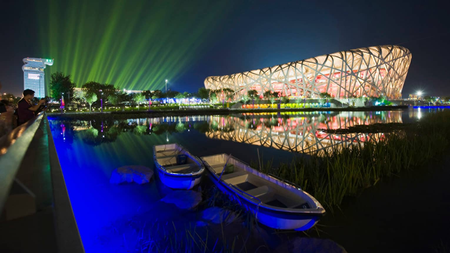 Exterior of Beijing National Stadium bird's nest-shaped building lit up at night