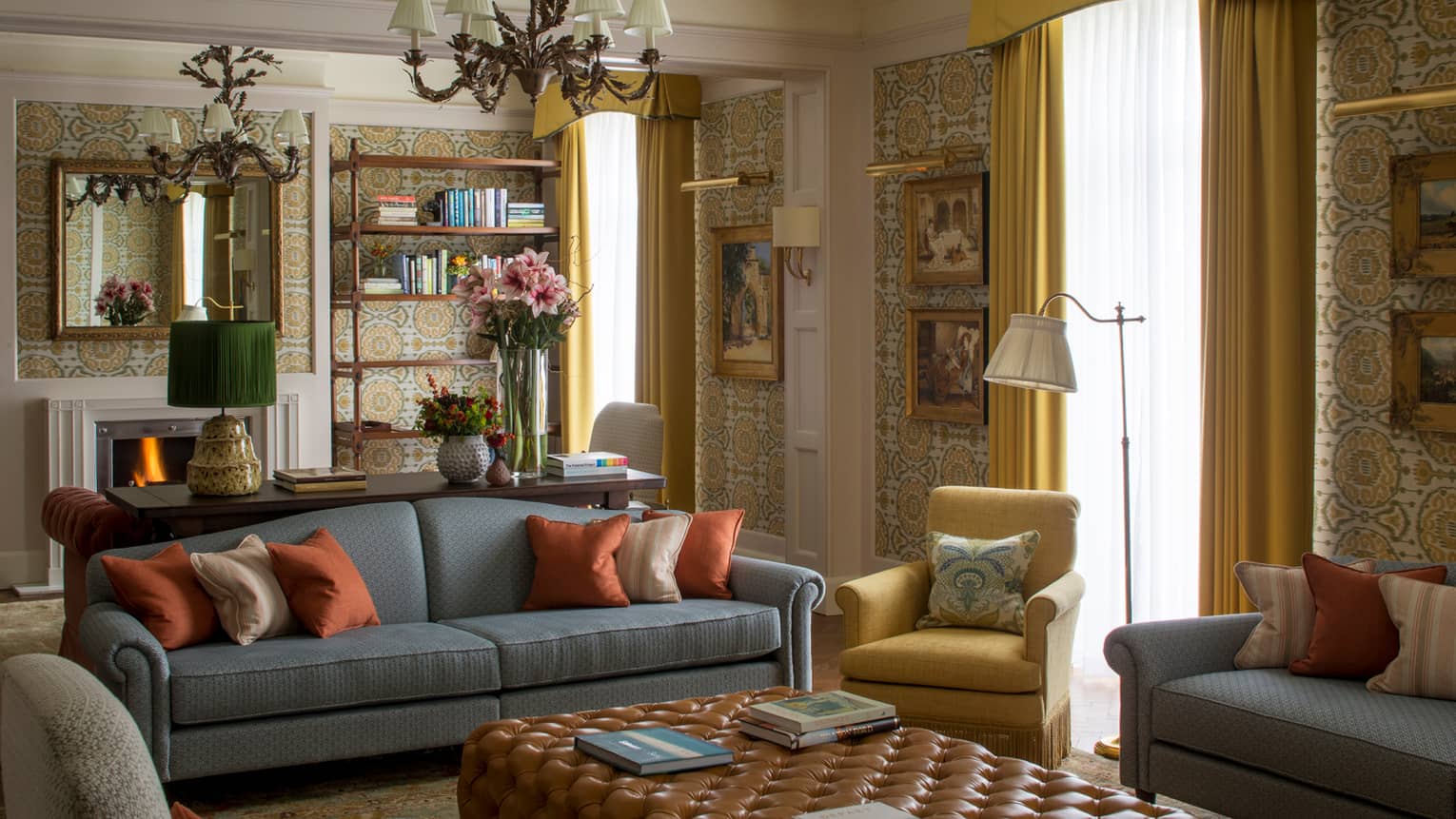 Royal Suite vintage wallpaper, gold-framed paintings, flowers around seating area
