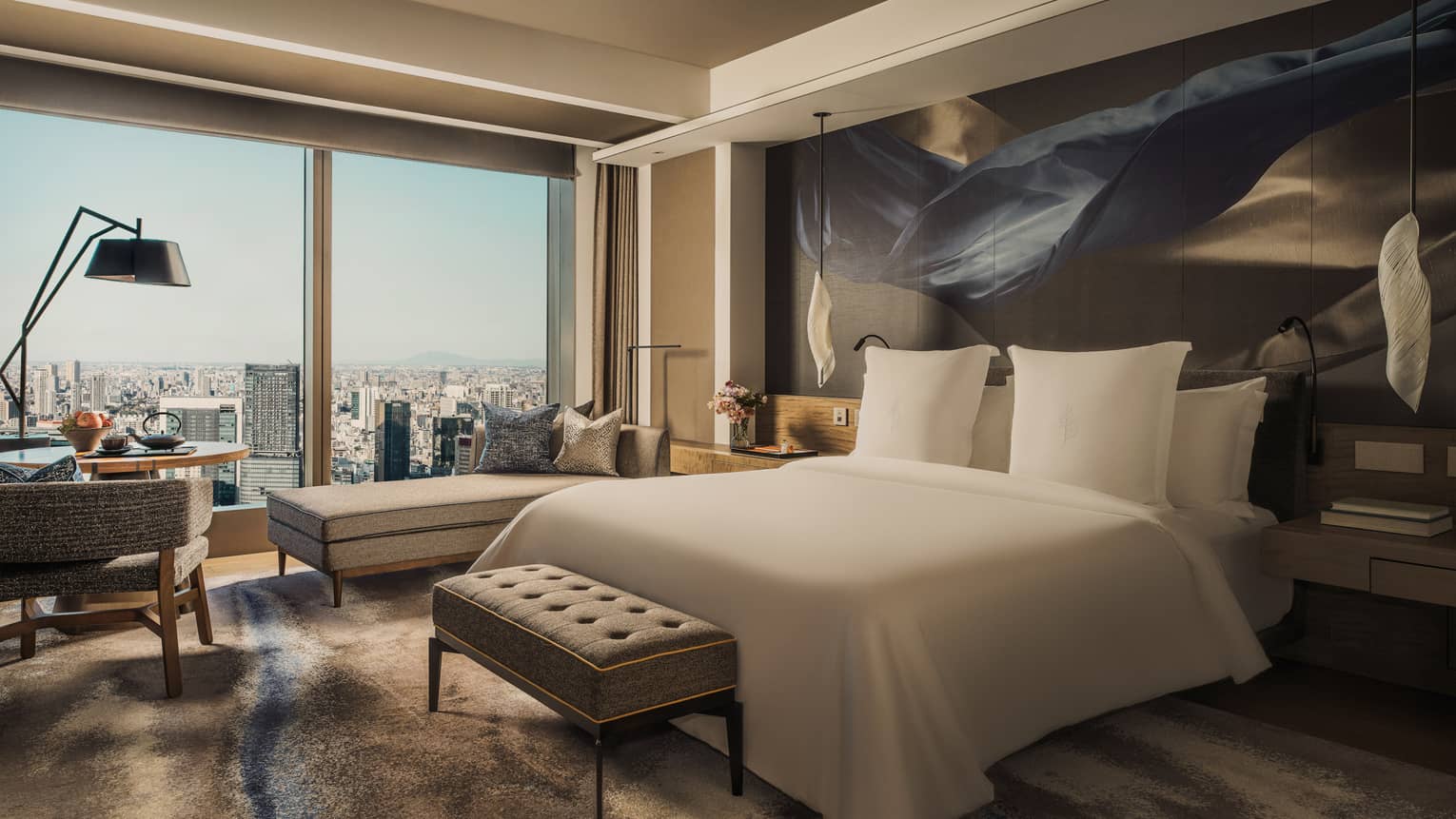 Luxury hotel guest room with king bed and city view