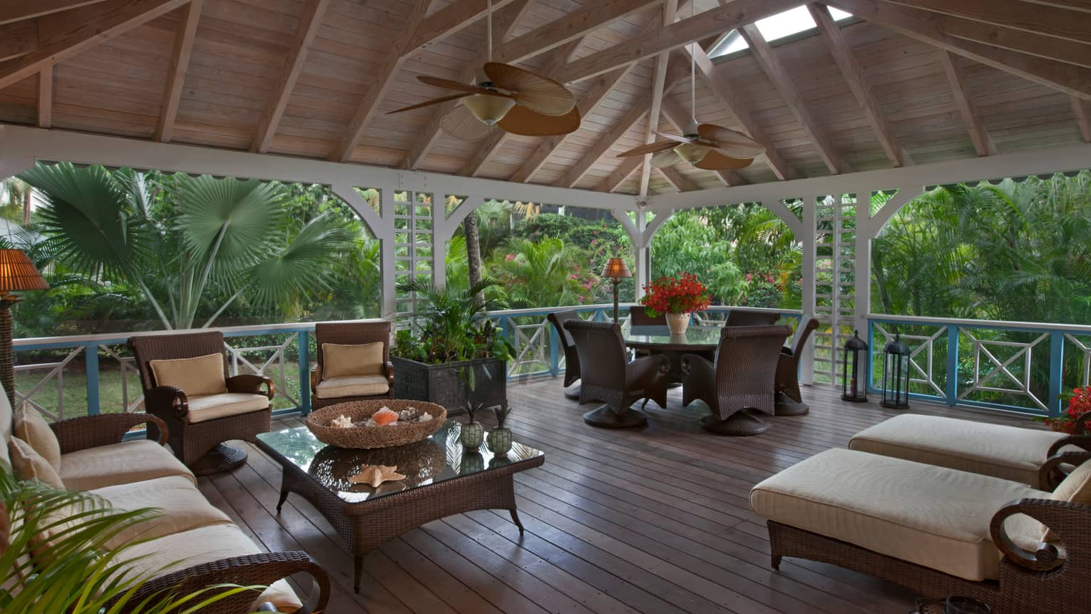 Palm Grove Residence patio, wicker furniture under soaring wood ceilings, fans