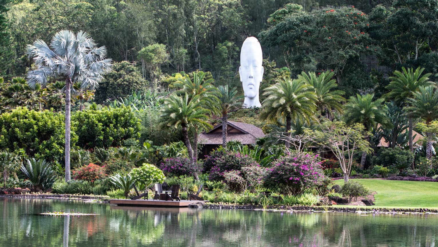 Lush tropical grounds of resort with sculpture head