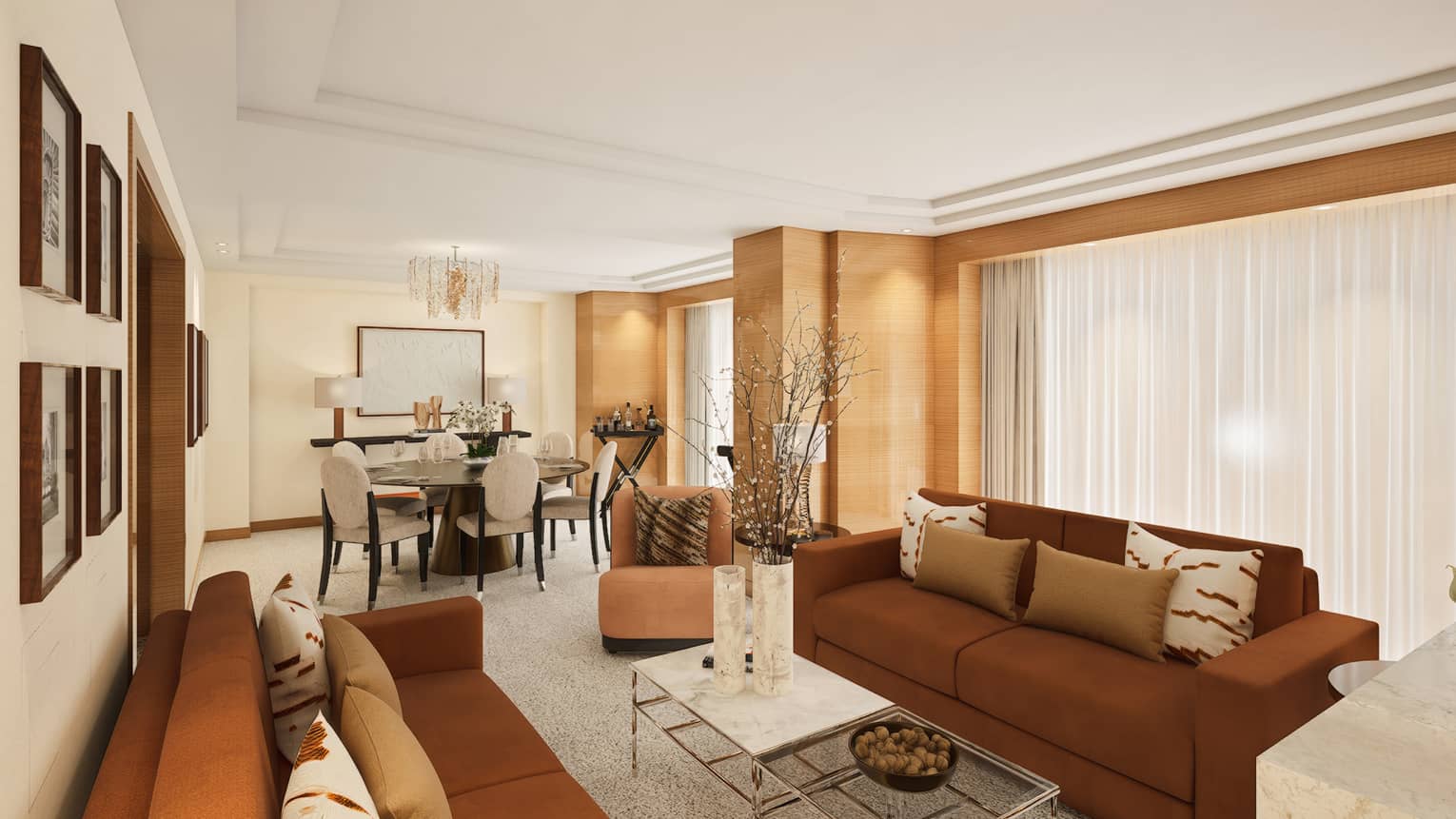 Hotel suite living room with two brown sofas facing inward toward coffee table, plus a dining table
