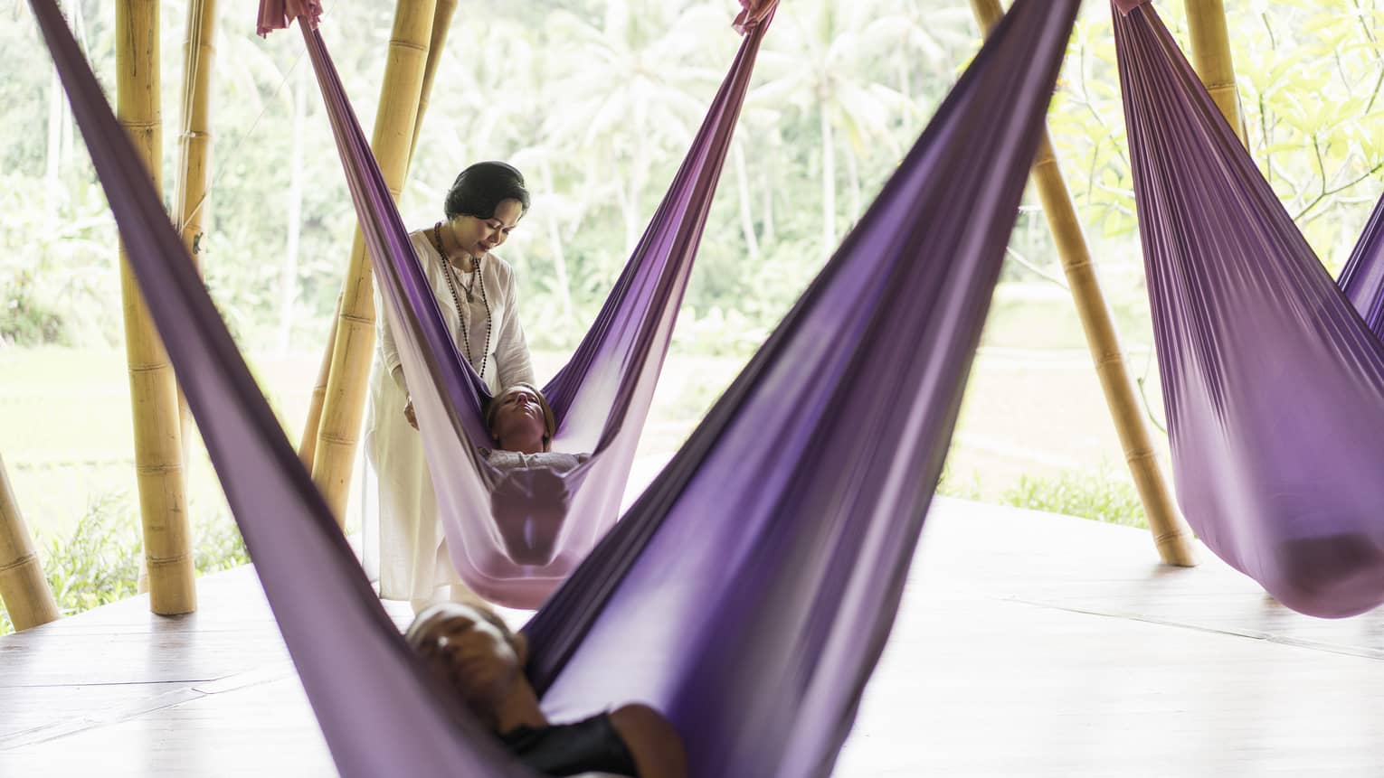 Guests taking a sacred nap in hanging fabric swings