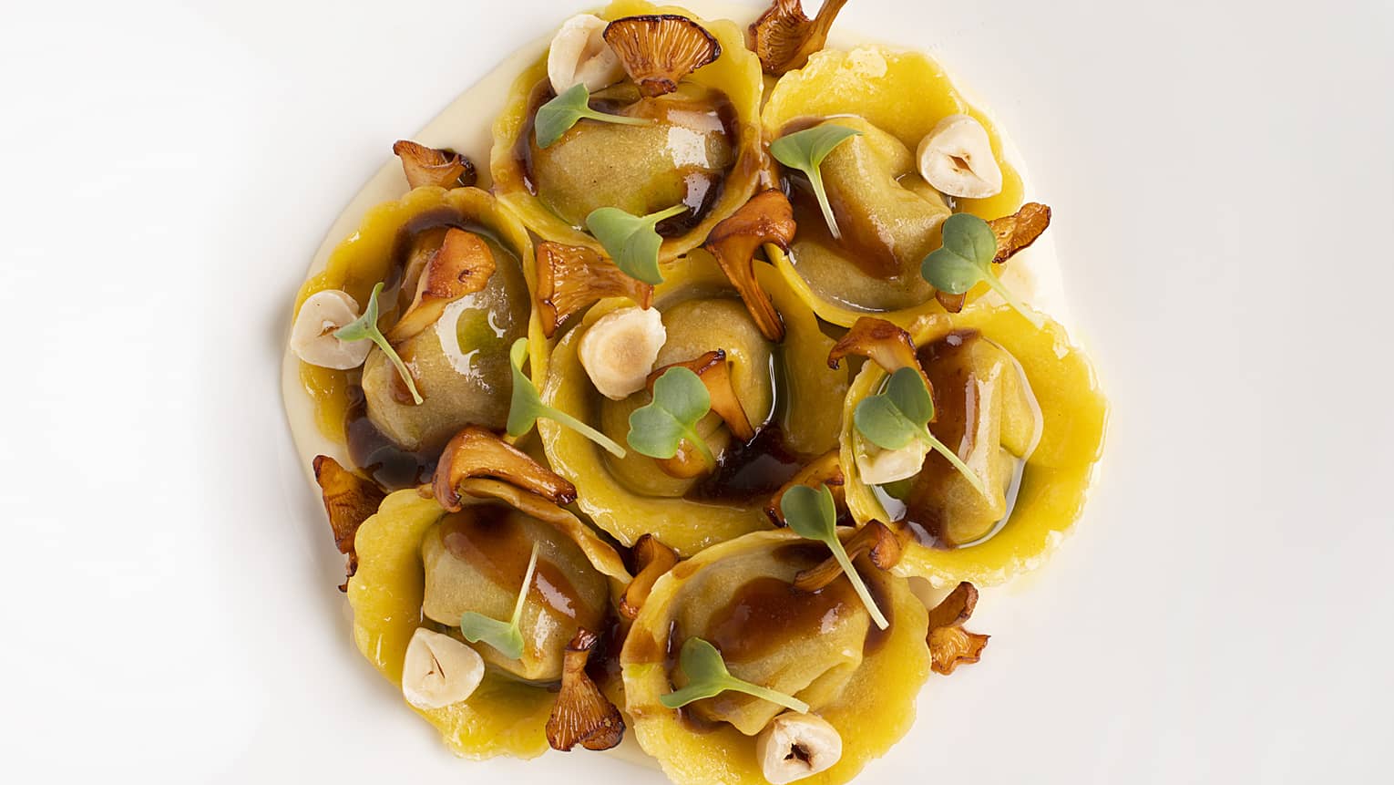 Several pasta shells stuffed with various cheeses and almonds, as well as spinach, mushrooms and meat.