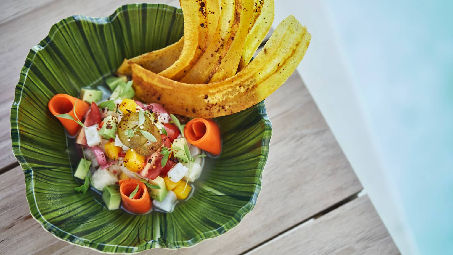 Poolside dining. View of tropical dish snapper ceviche with Florida mango