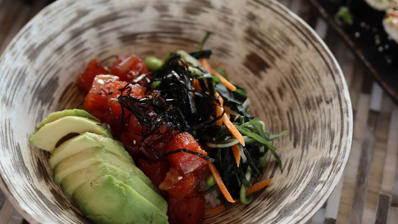 A tabletop holding bowls and platters of colourful food items