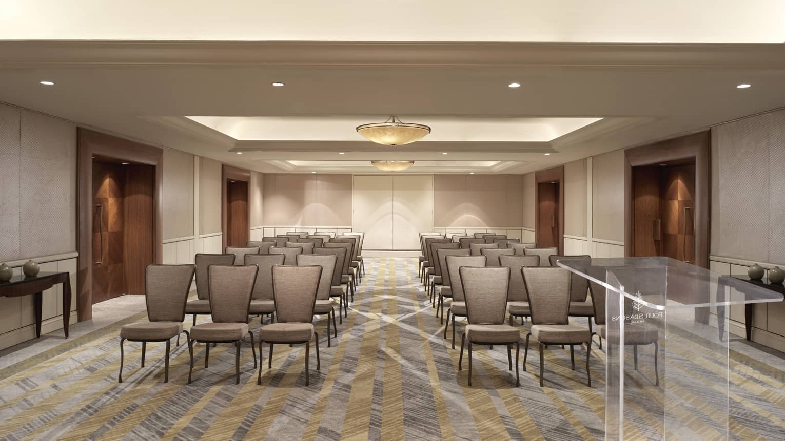 Plush grey seats set up theatre style facing the camera.