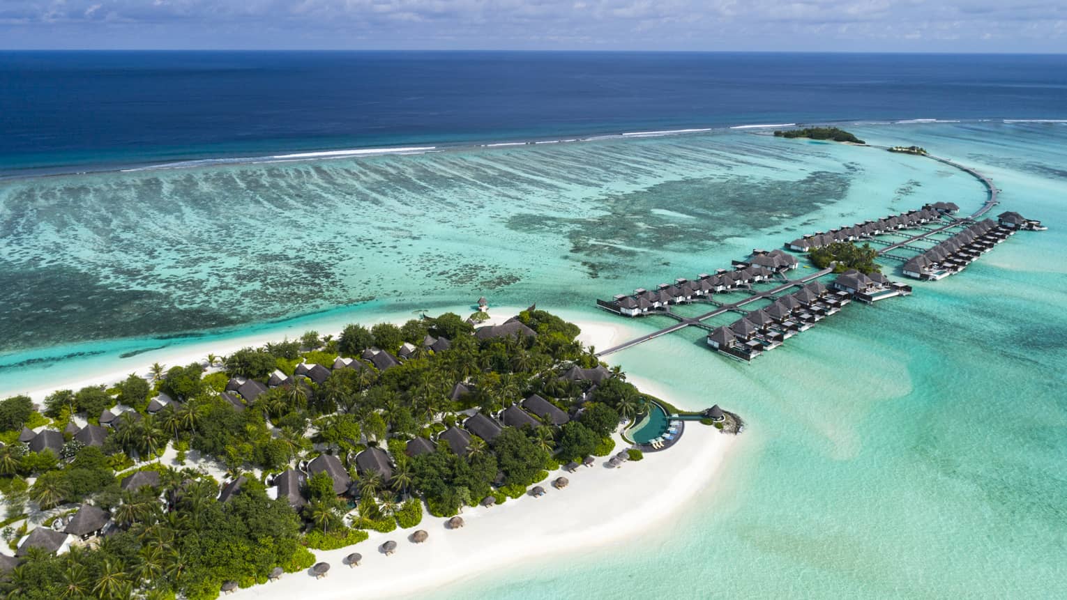 Aerial view of Maldives beach island with overwater bungalows
