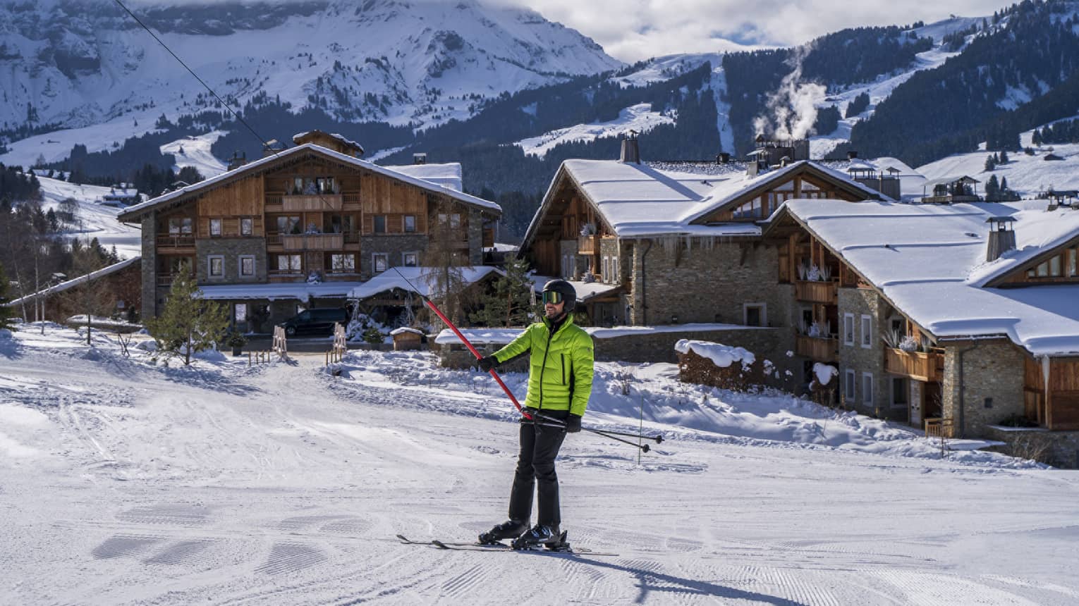 A person in a bright green ski jacket on snow.