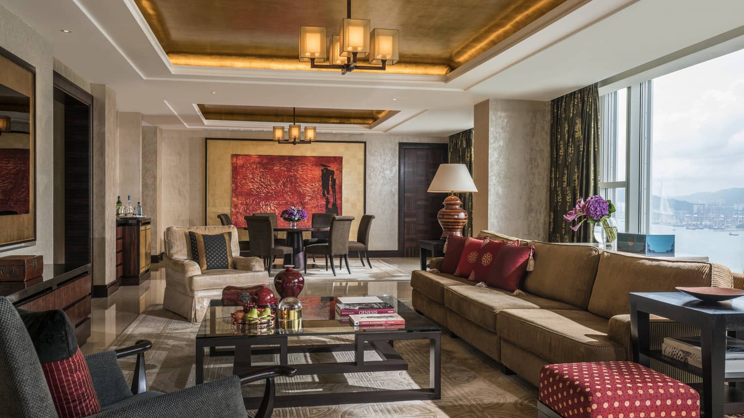 Imperial Suite large living room with plush sofas, armchairs, wall-length window with harbour view