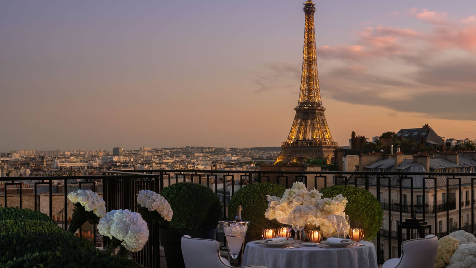 Private terrace set for dinner with prime view of the Eiffel Tower in the evening