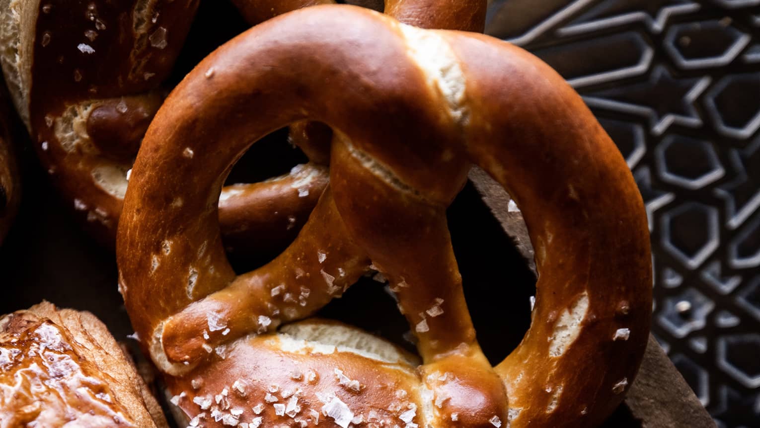 Giant pretzels next to various croissants