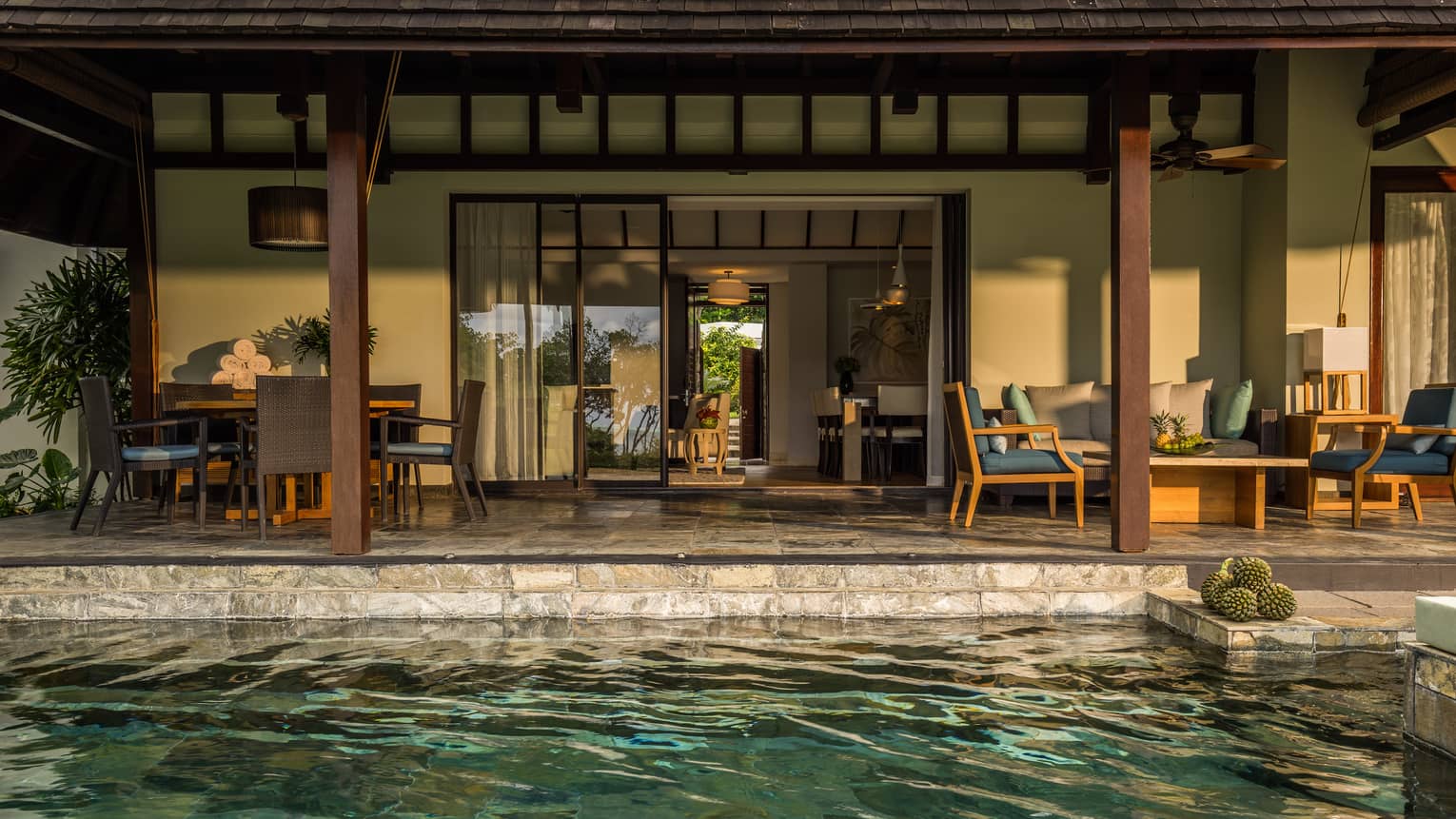 Garden Residence Villa plunge pool in front of stone patio dining table, seating area