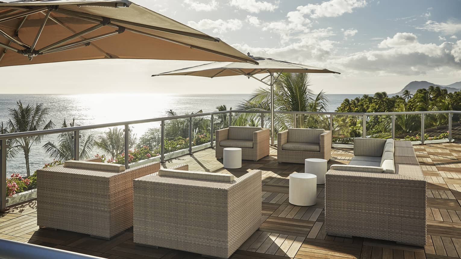 Presidential Suite patio with large wicker chairs, parquet floors, umbrellas, ocean view
