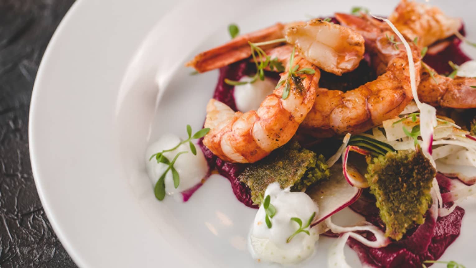 Shrimp served on a bed of vegetables.