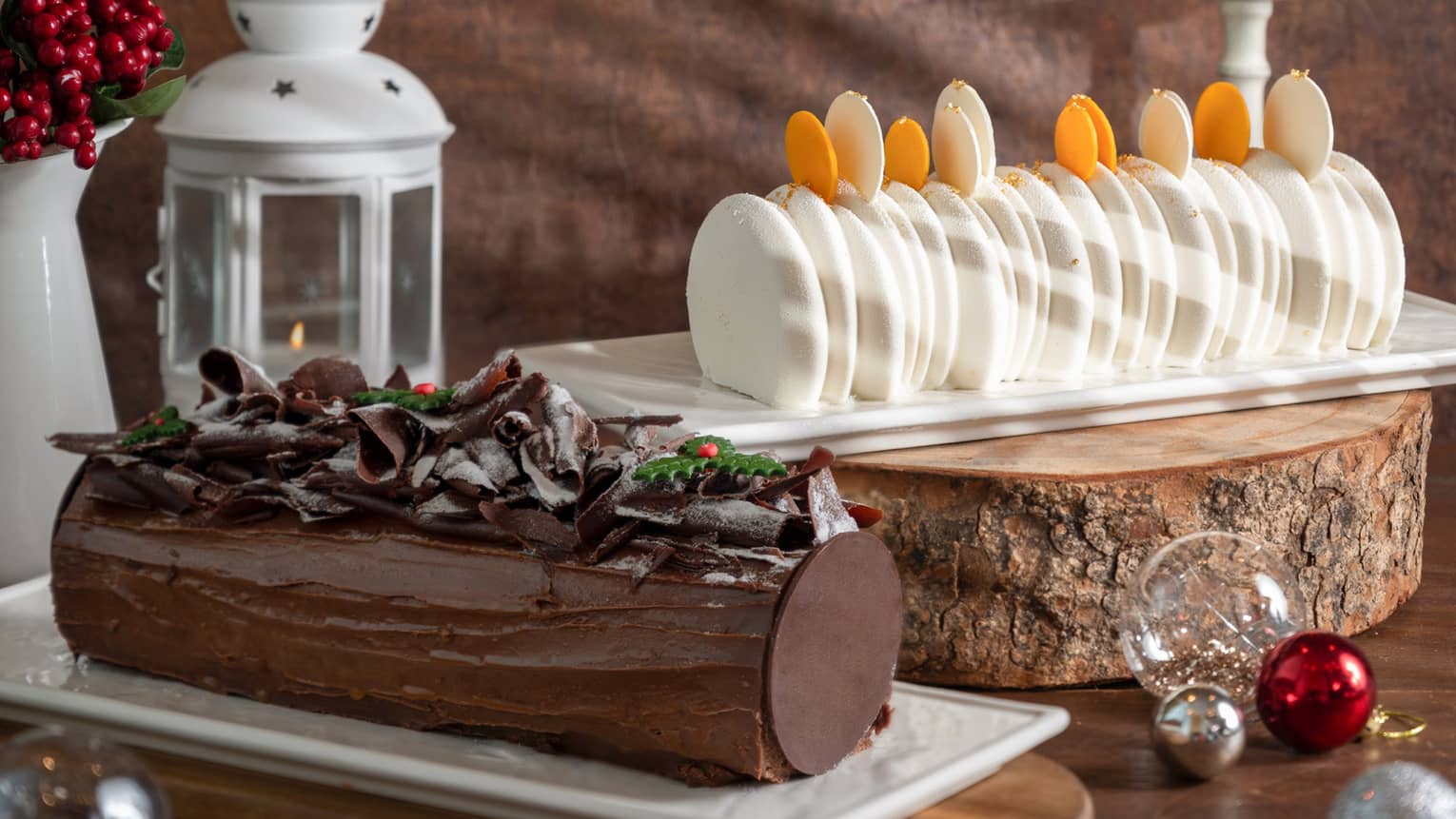 Festive yule log cakes, one chocolate one vanilla