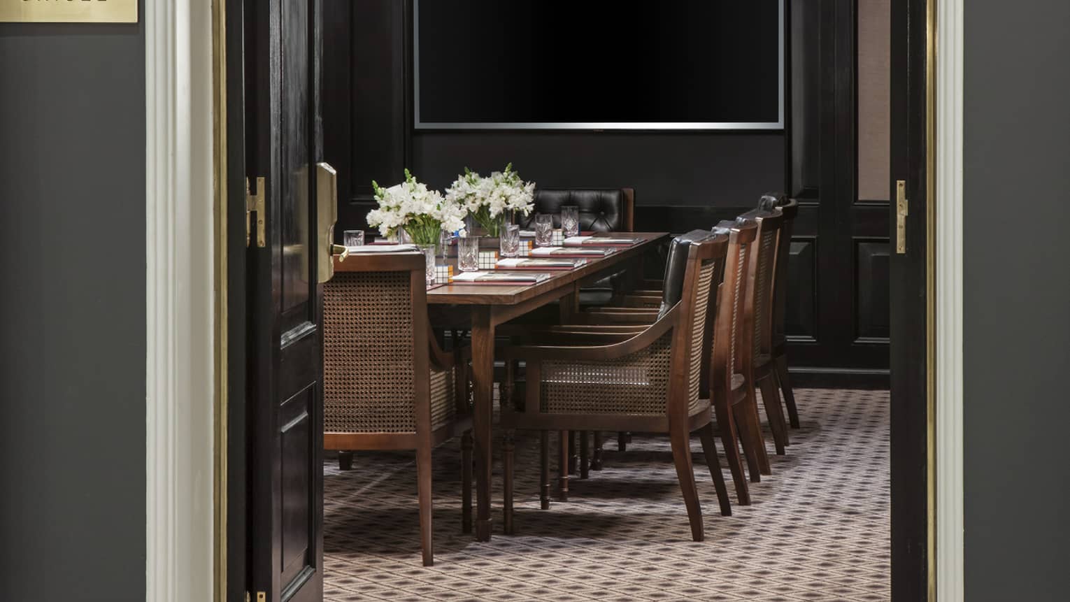 Arched entrance to Gricel Meeting Room with boardroom table and chairs 