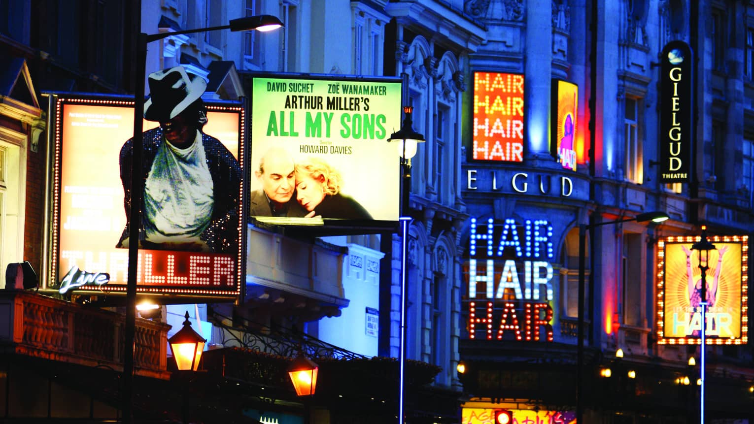 Historic buildings and neon billboards along London theatre district 