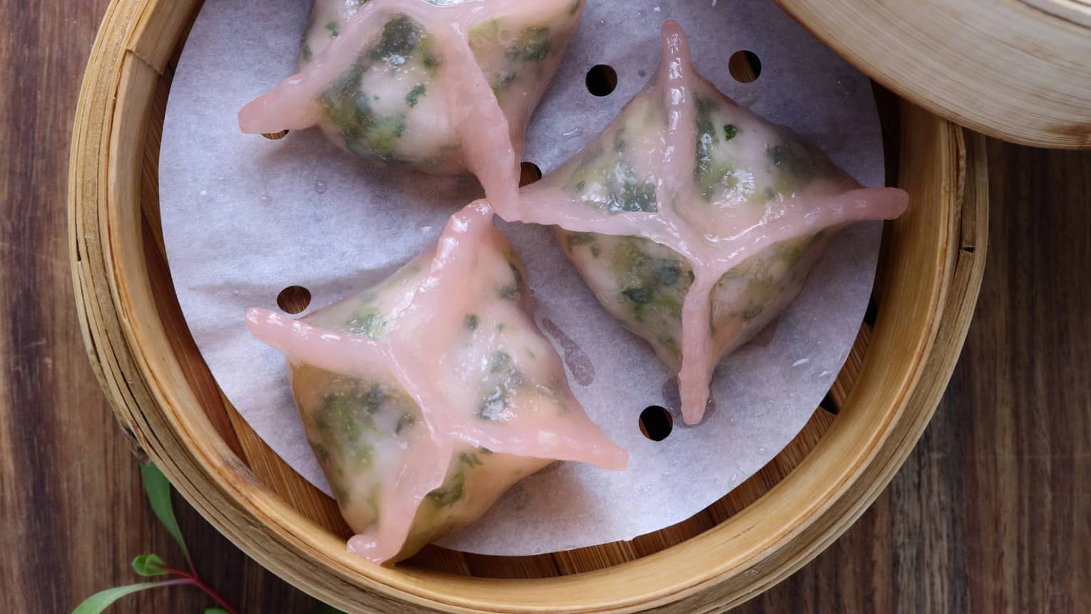 Aerial view of three Steamed Vegetable Dumplings in bamboo steamer 
