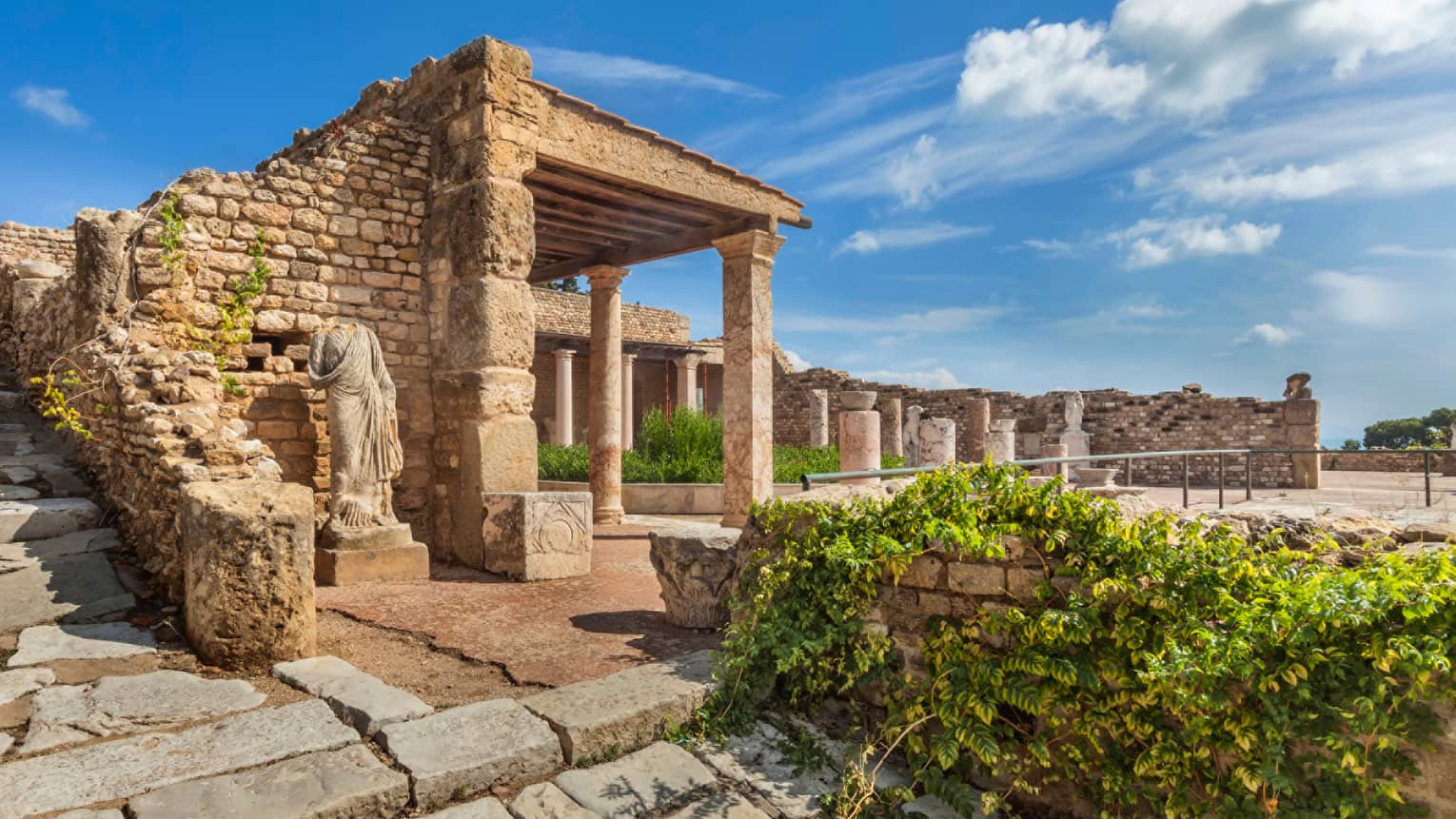 Statue under stone Ruins of Carthage, blue sky