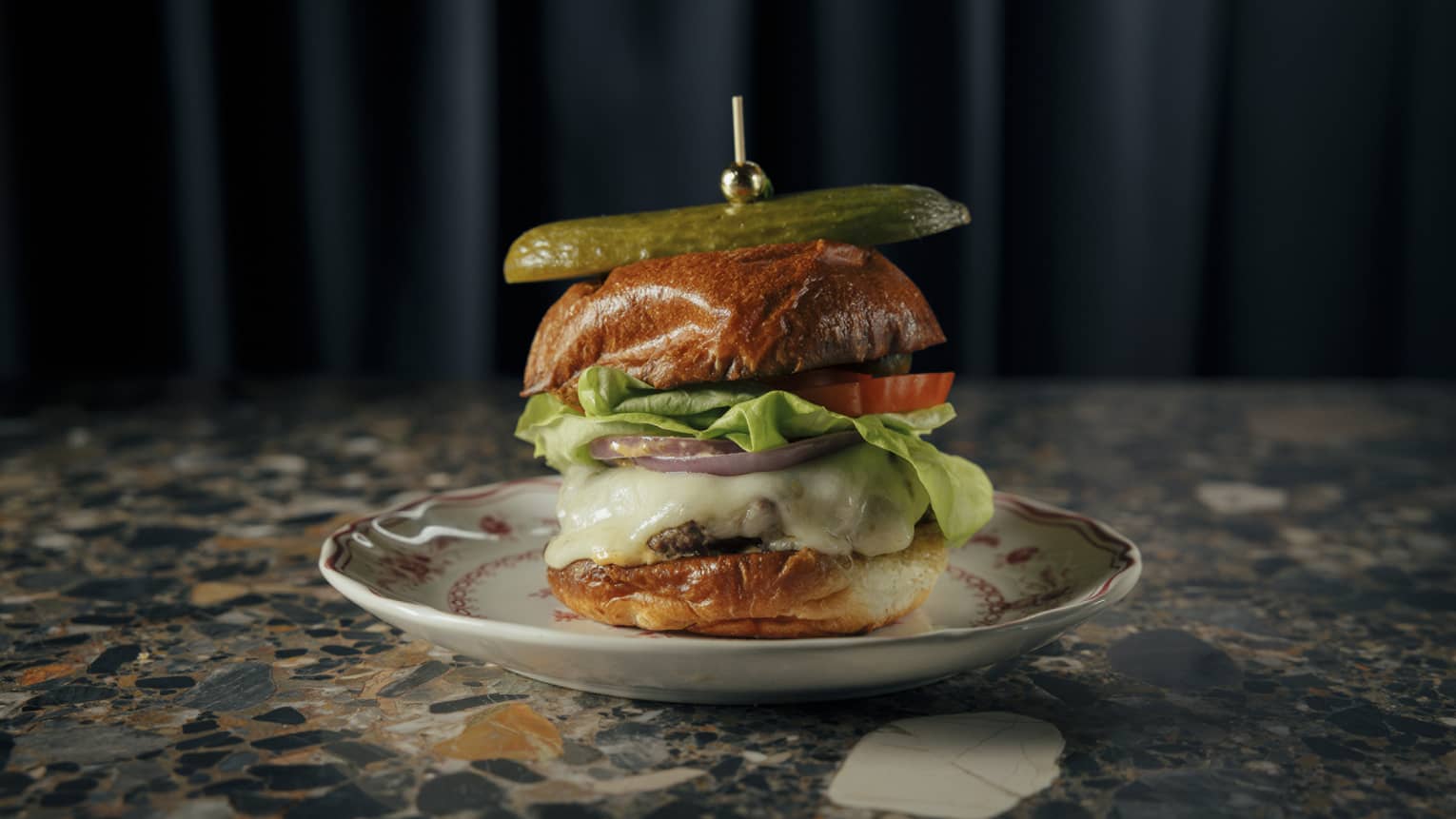 Cheeseburger topped with a pickle