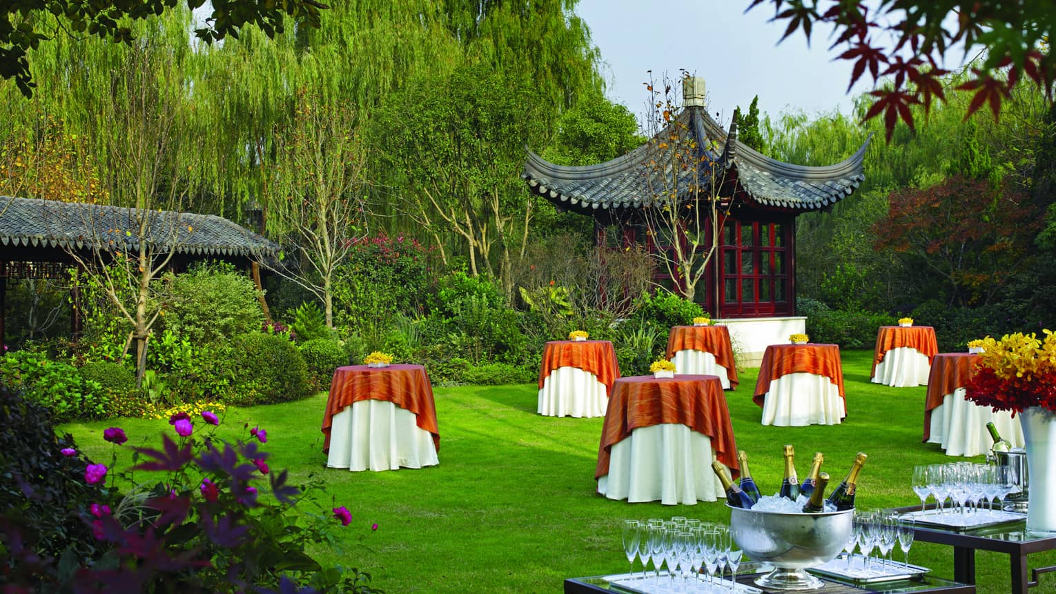 Outdoor function space small cocktail tables along green lawn