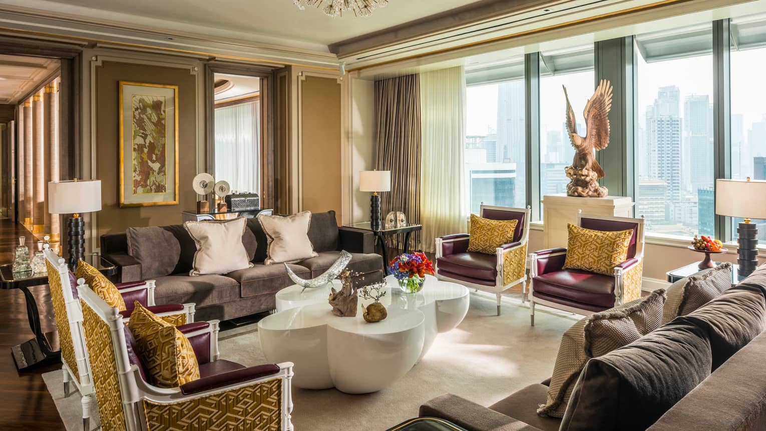 Presidential Suite foyer with two sofas and four armchairs with accent pillows, large modern white coffee table, large eagle statue