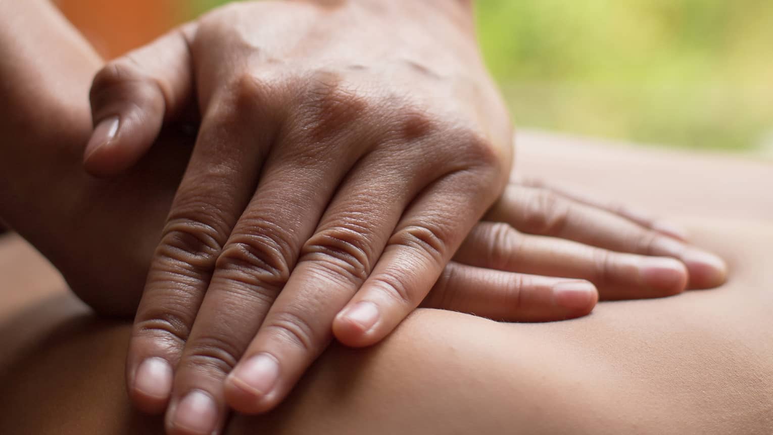 Close up of hands massaging a back
