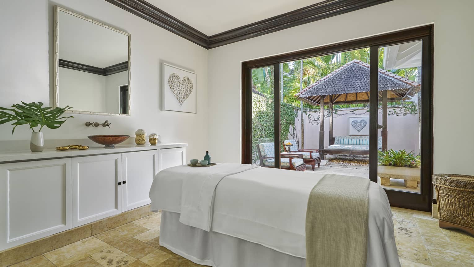 A spa treatment with a large window looking outside.