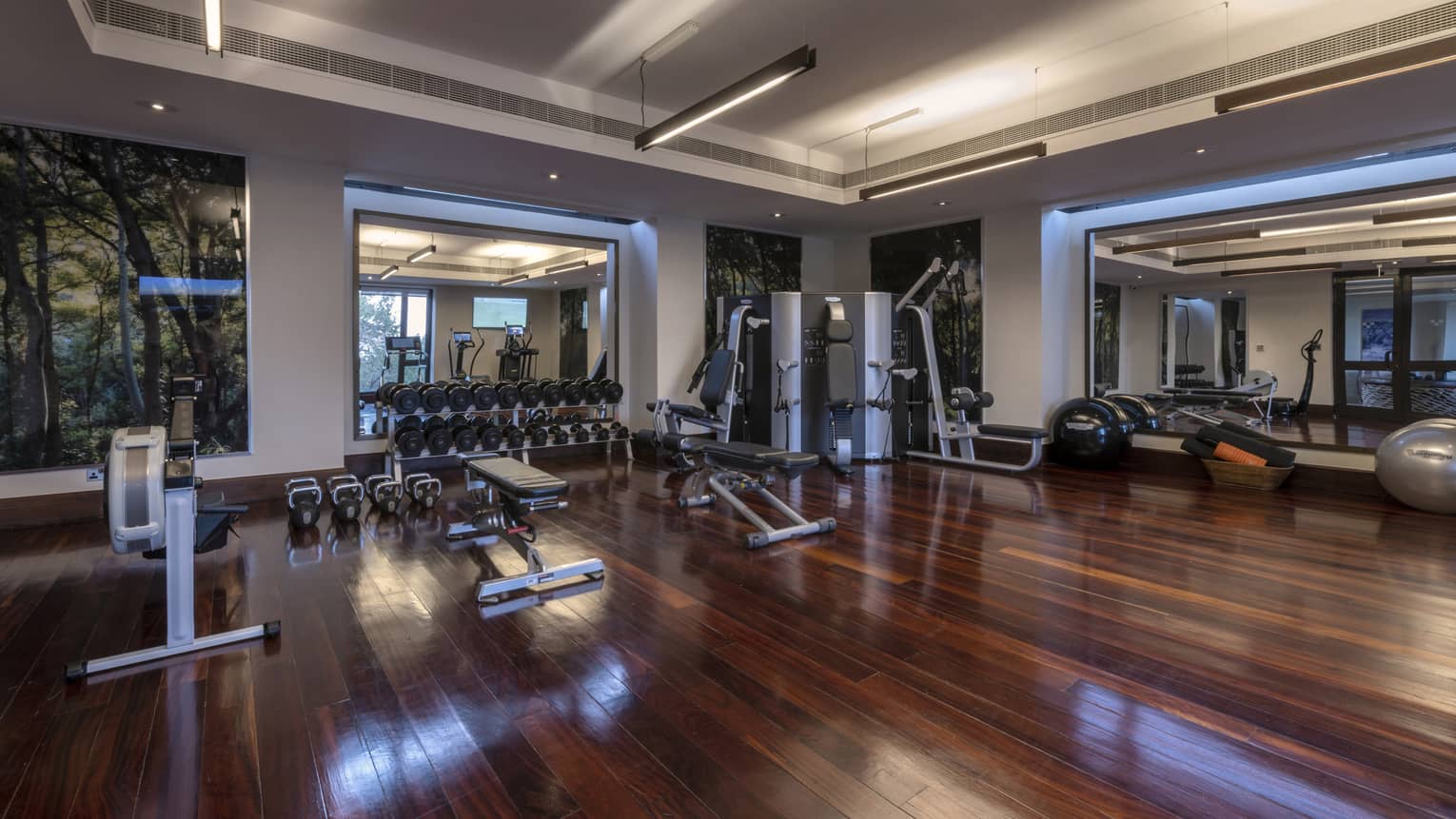 Large Fitness Centre with hardwood flooring, state-of-the-art equipment, tall windows and high ceilings