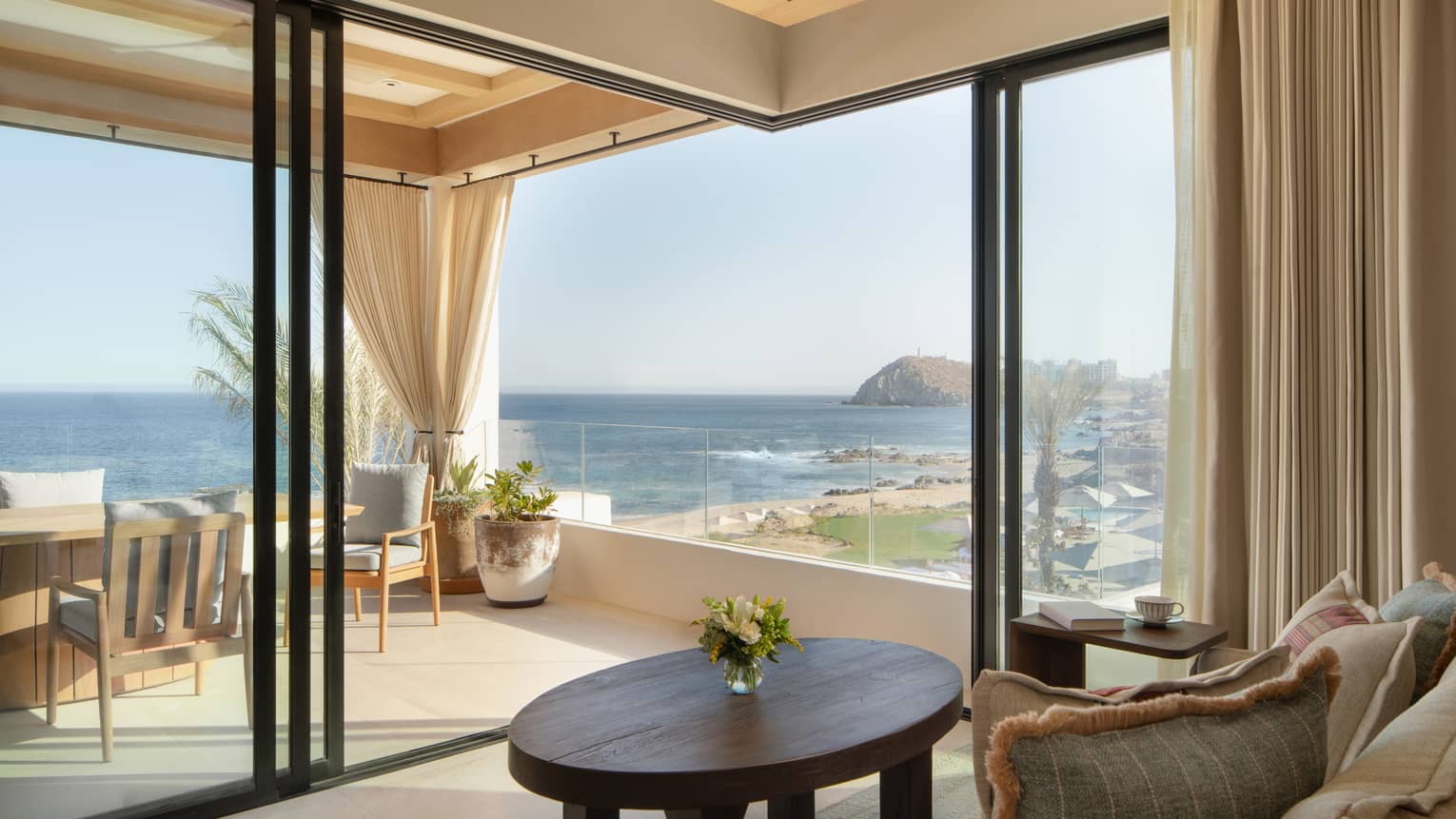 Chic sitting room of oceanfront casita suite looking out to terrace and ocean at Four Seasons Resort Cabo San Lucas at Cabo Del Sol