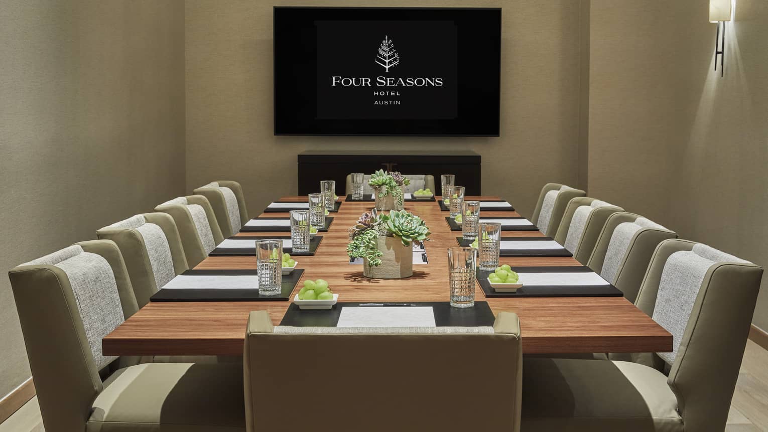 Bouldin Creek meeting room with long boardroom table, screen with Four Seasons logo 