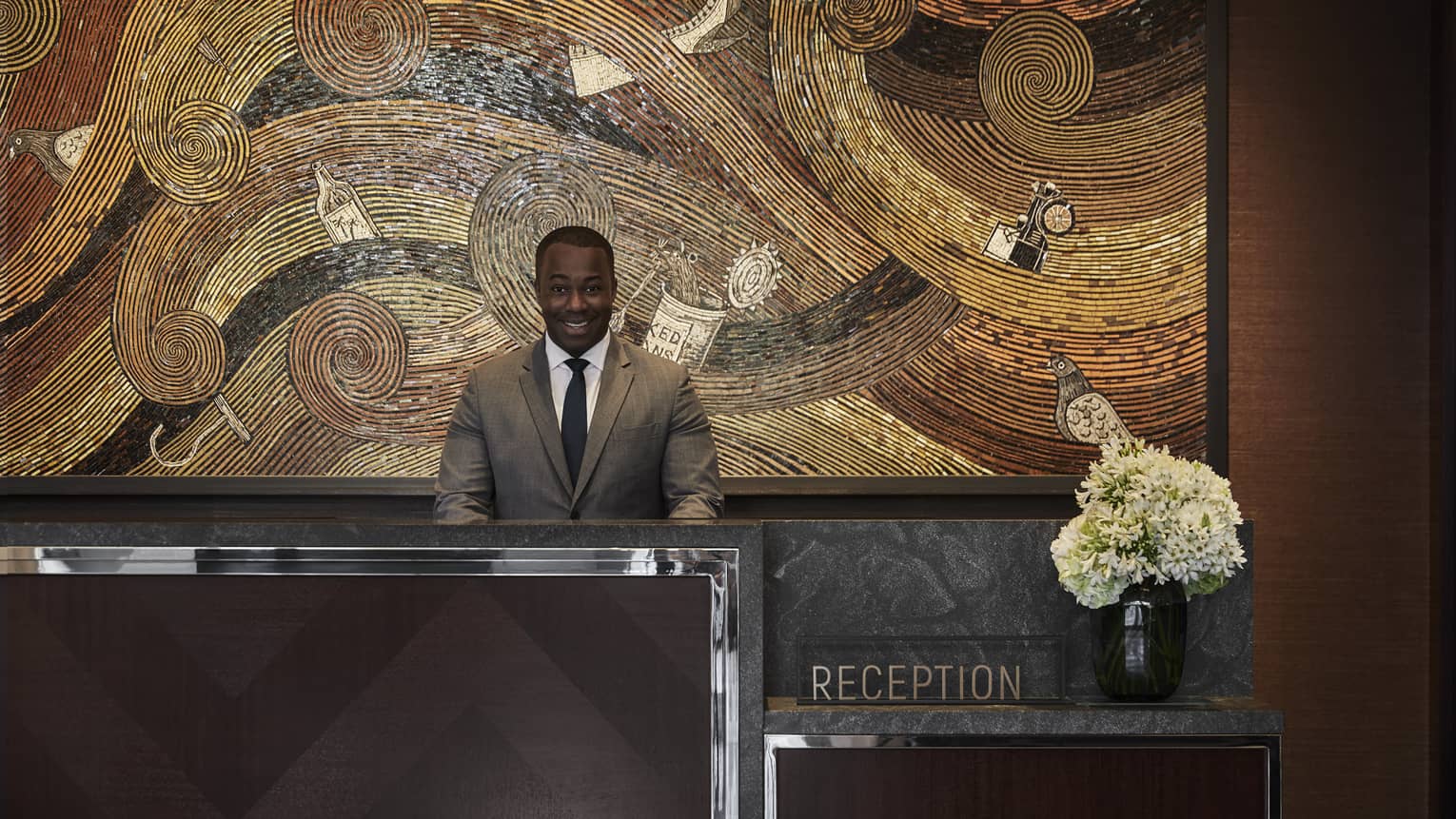 A four seasons staff working at the reception desk