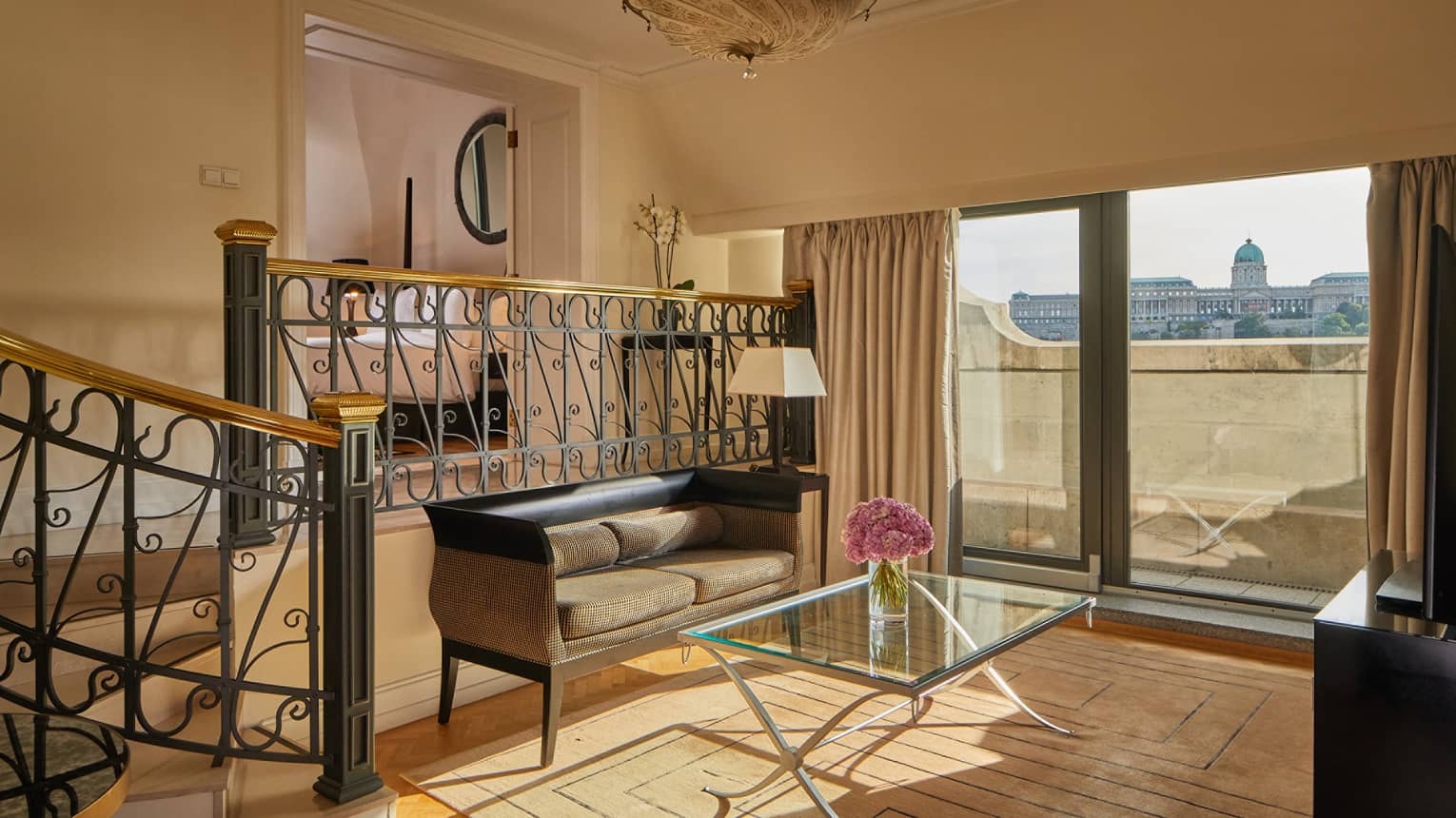 A small area with a window, small sofa and glass table.