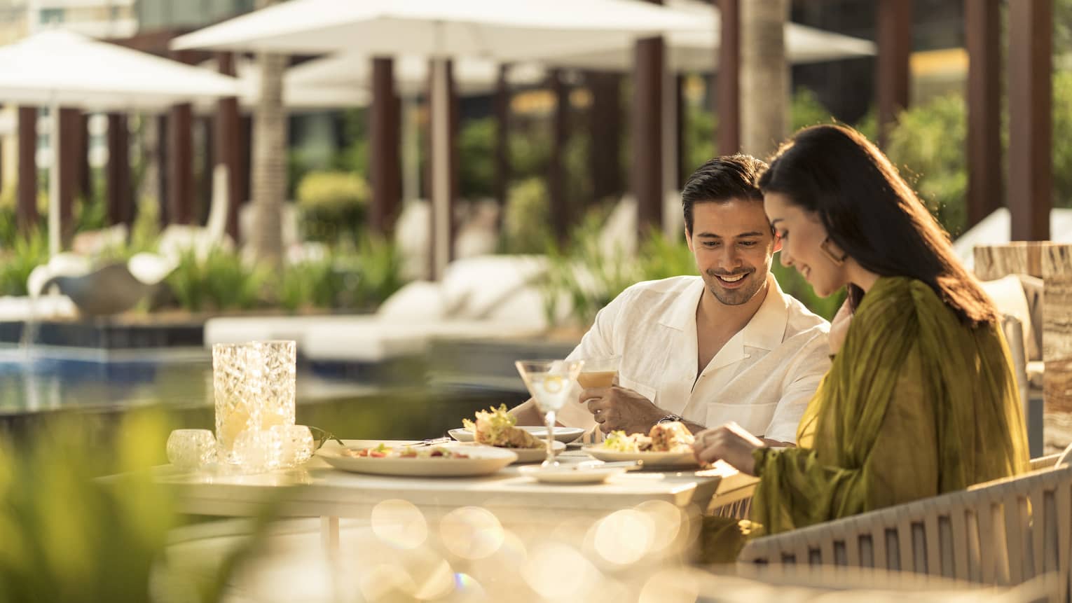 A couple eats together at Pool Bar and Grill