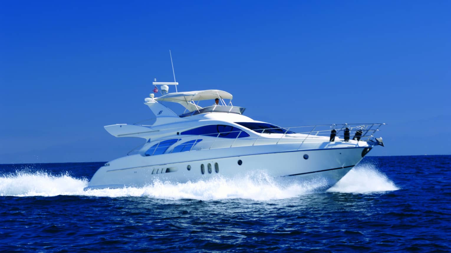 White Four Seasons private luxury yacht speeds across ocean