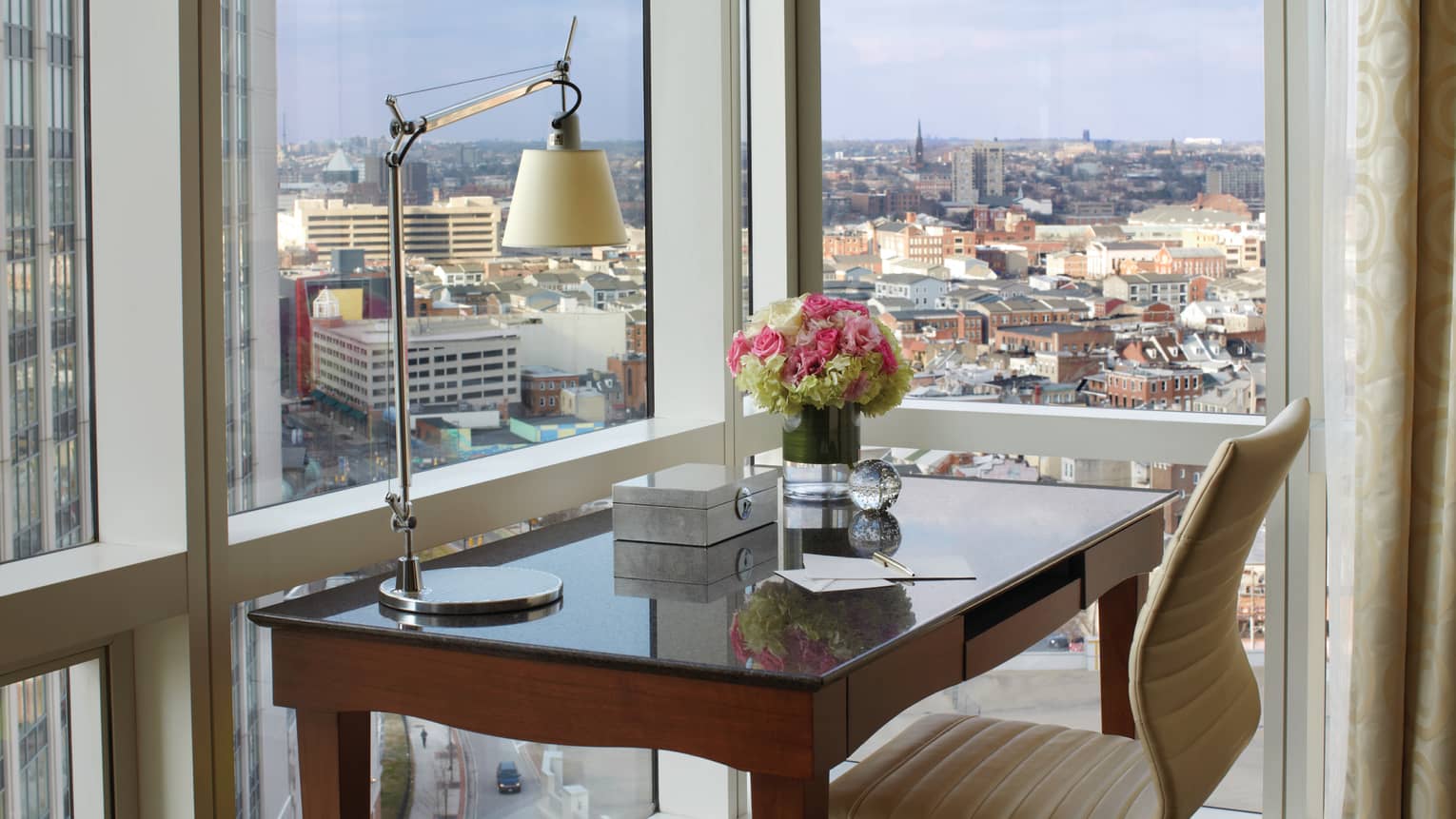City-View Accessible Room writing desk with reading lamp, notepad, fresh flowers at window