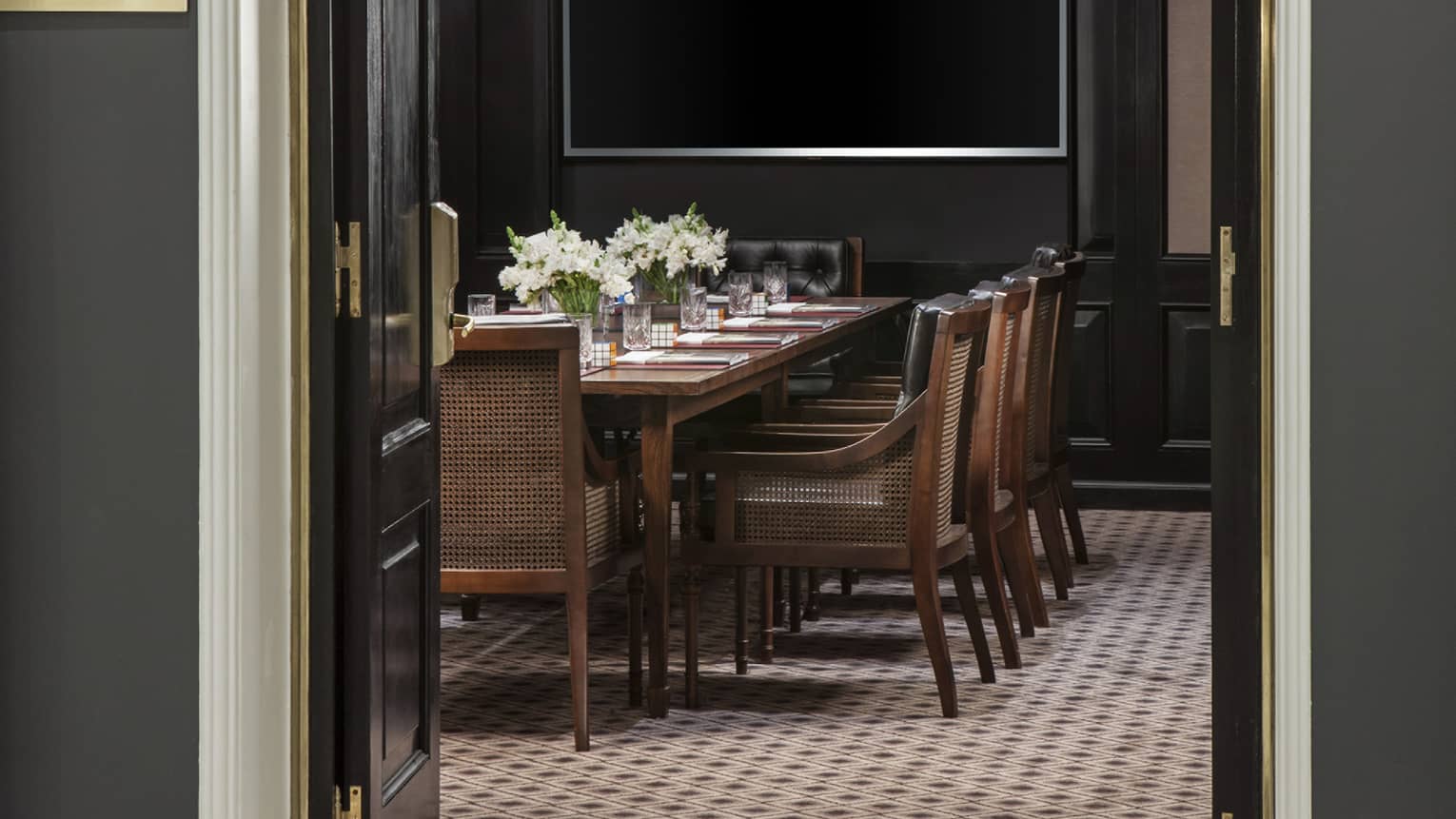 Arched entrance to Gricel Meeting Room with boardroom table and chairs 