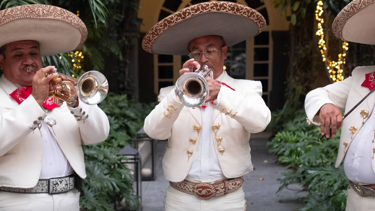 Three piece Mariachi band wearing white suits