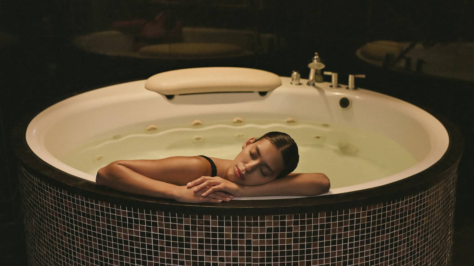 Guest relaxes in a spa whirlpool