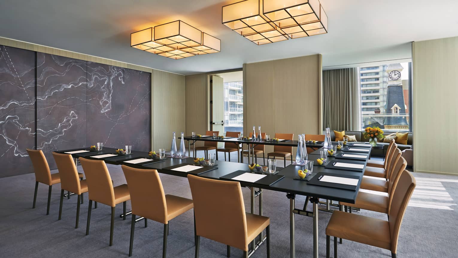 Modular meeting table under square lights, modern marble accent wall