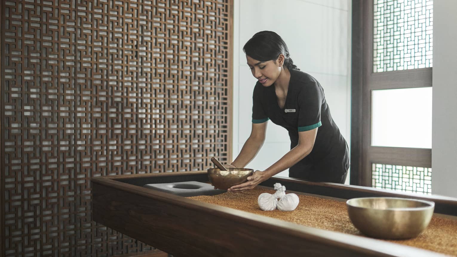 Pear Spa staff places copper bowl on table