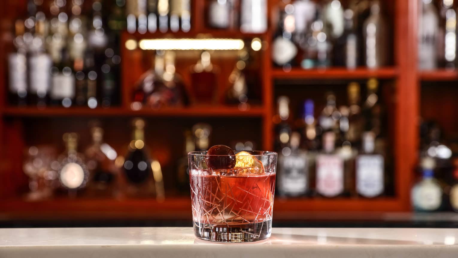 Old Fashioned cocktail in glass on bar 