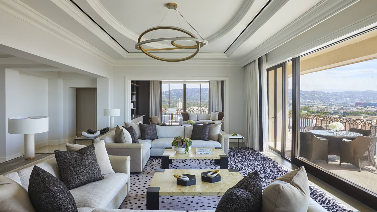 Large living room opening to city-view terrace