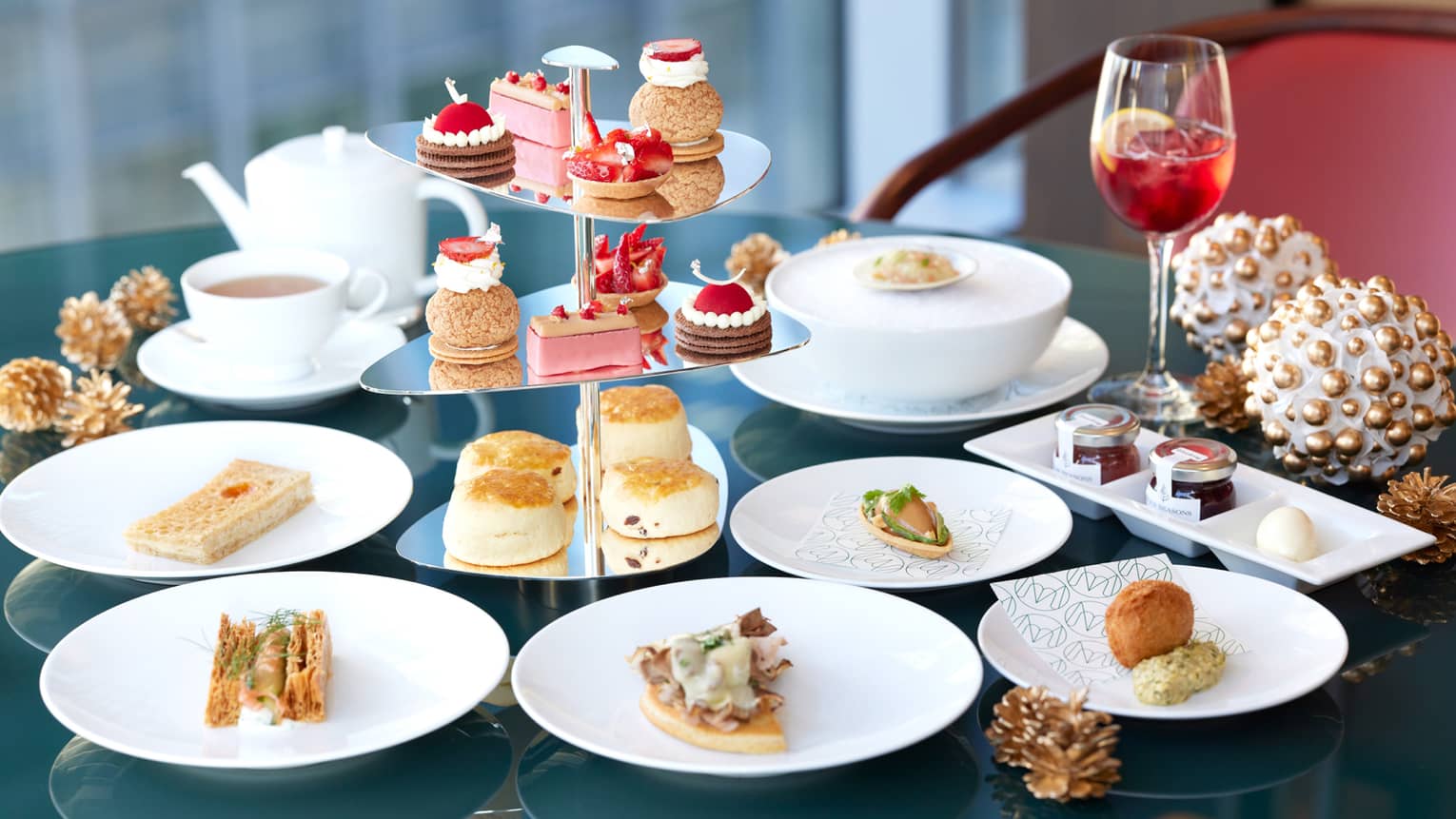 Festive Afternoon Tea spread with pastry tower and holiday cocktail